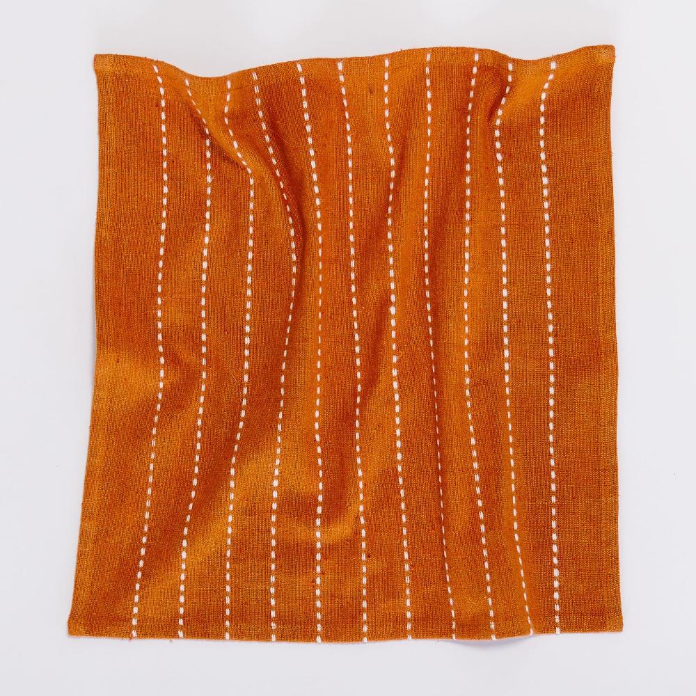 Copper cocktail napkin laid open, showing the full line pattern