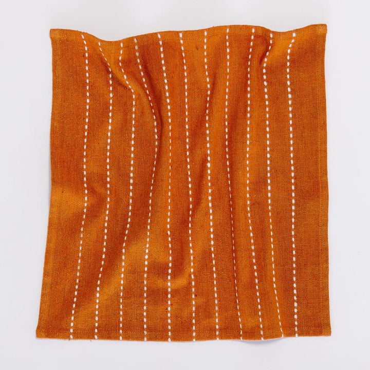 Copper cocktail napkin laid open, showing the full line pattern
