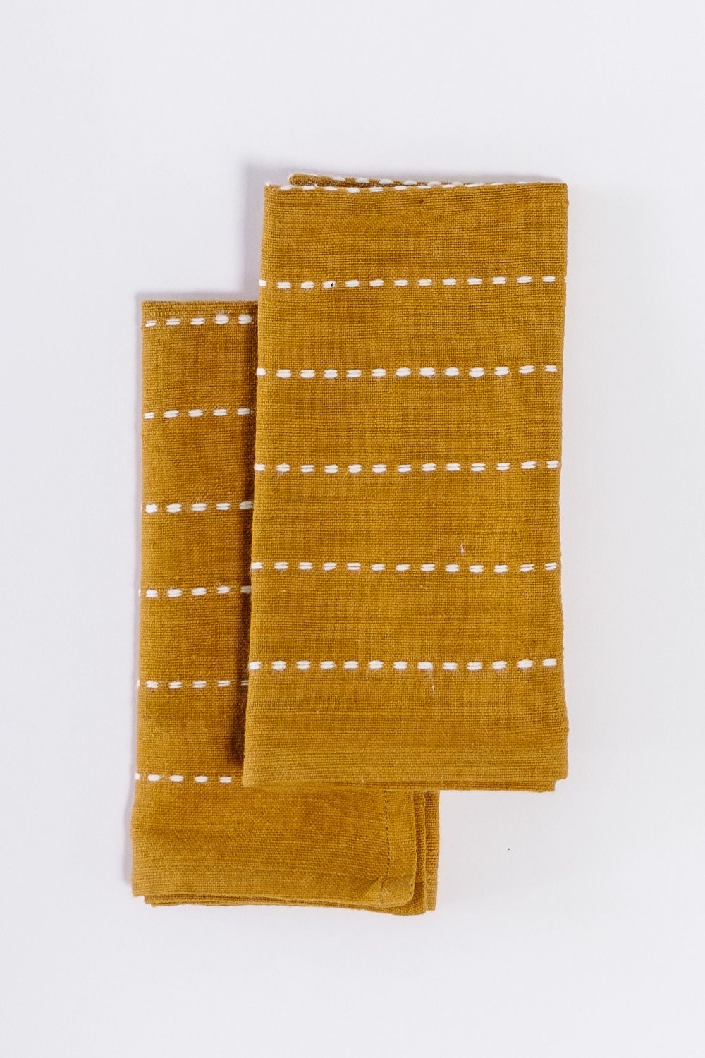 Pair of bronze handwoven cotton cocktail napkins, folded