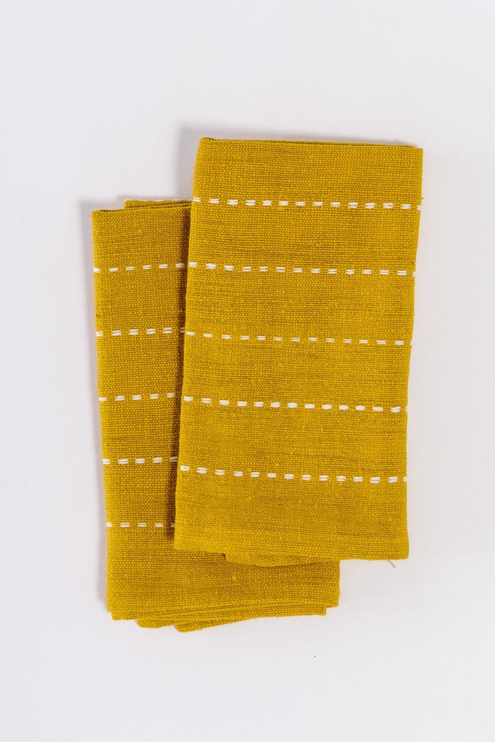 Pair of gold handwoven cotton cocktail napkins, folded