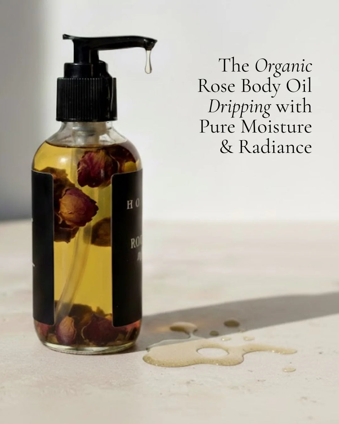 Organic rose body oil in a clear glass bottle with a dropper.