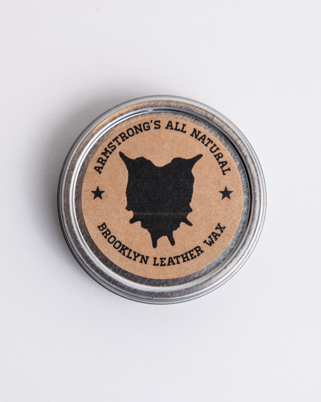 Brooklyn Leather Wax for natural leather protection, shown with the tin and a leather surface.