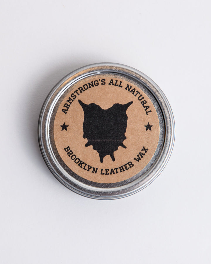 Brooklyn Leather Wax for natural leather protection, shown with the tin and a leather surface.