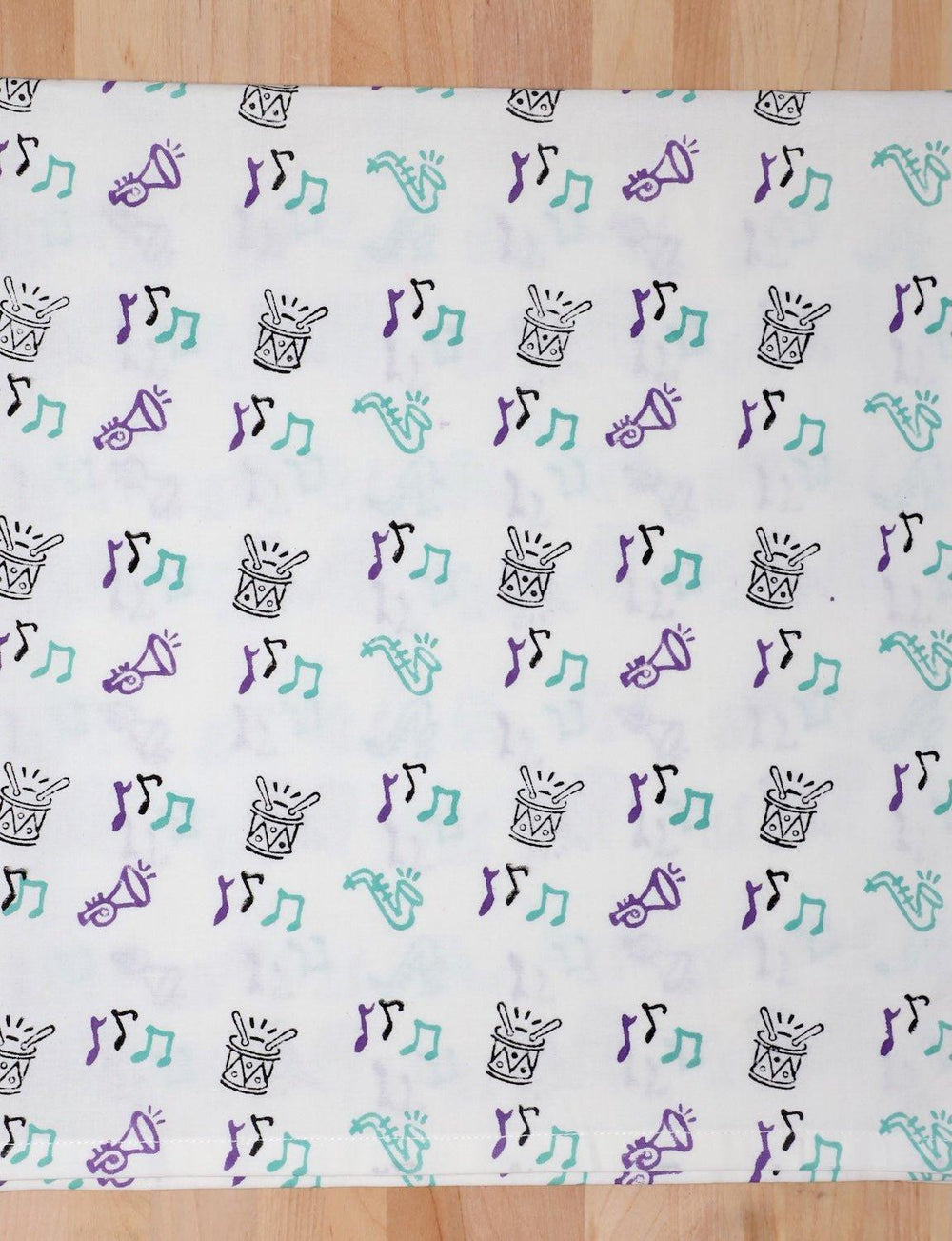 Second Line cotton tea towel with a hand block printed music design.