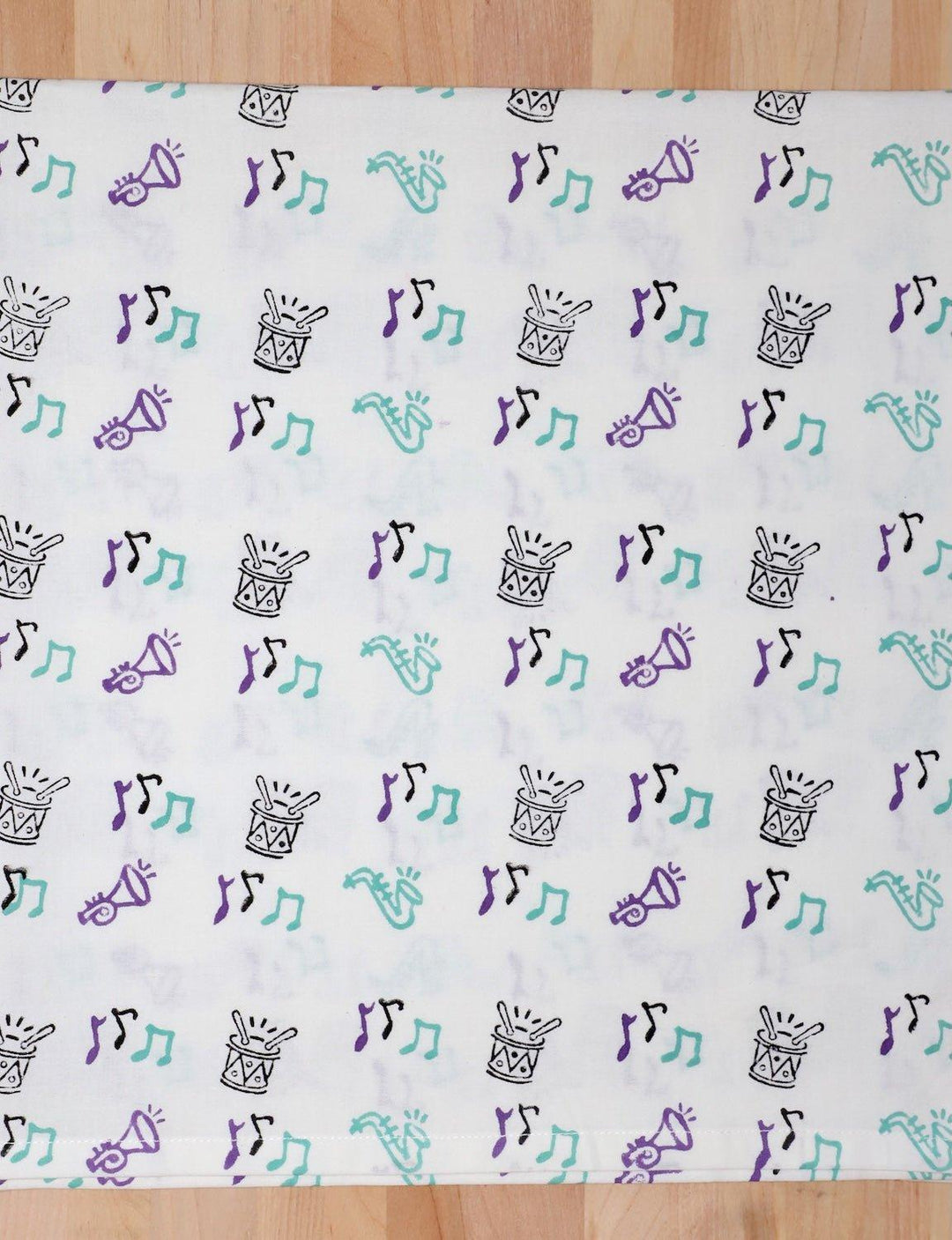Second Line cotton tea towel with a hand block printed music design.