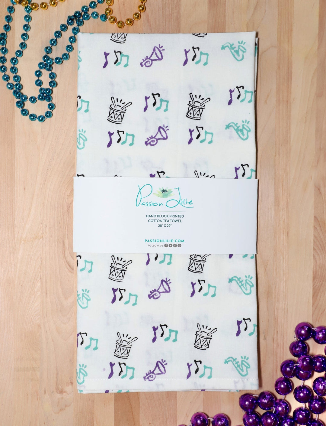 Second Line cotton tea towel, hand block printed with saxophones, drums, and music notes.