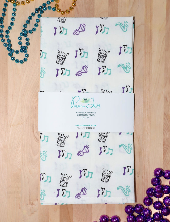 Second Line cotton tea towel, hand block printed with saxophones, drums, and music notes.