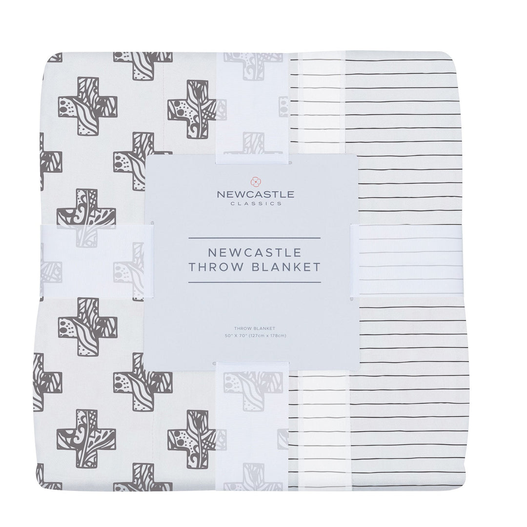 Bamboo muslin throw in a Nordic stamp stripe, lightweight and folded, soft texture.