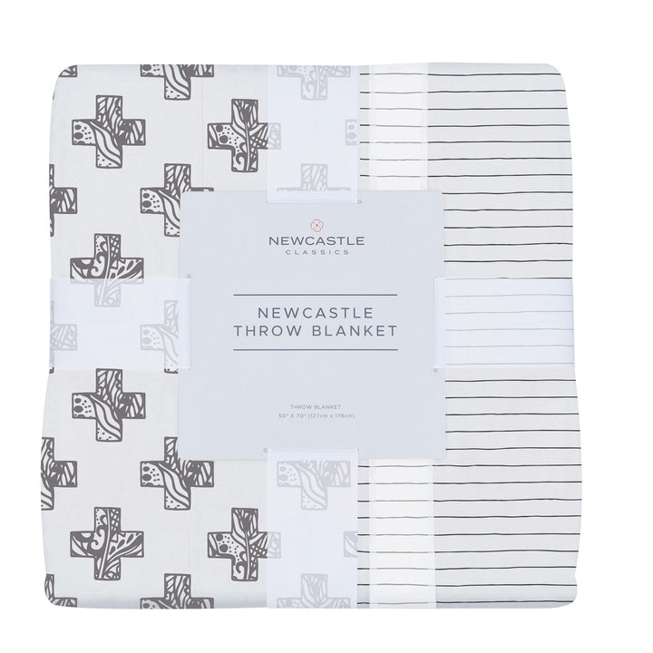 Bamboo muslin throw in a Nordic stamp stripe, lightweight and folded, soft texture.