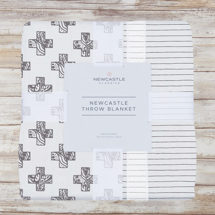 Bamboo muslin throw with a Nordic stamp and pencil stripe, cooling lightweight design.