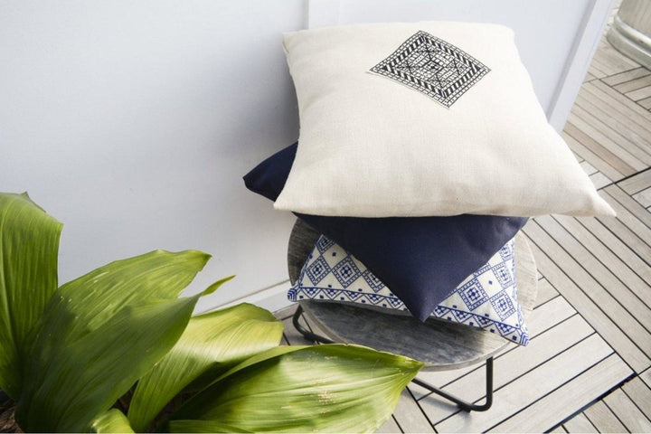Close-up of the black-and-white Diamond tatreez embroidery on a natural pillow cover.