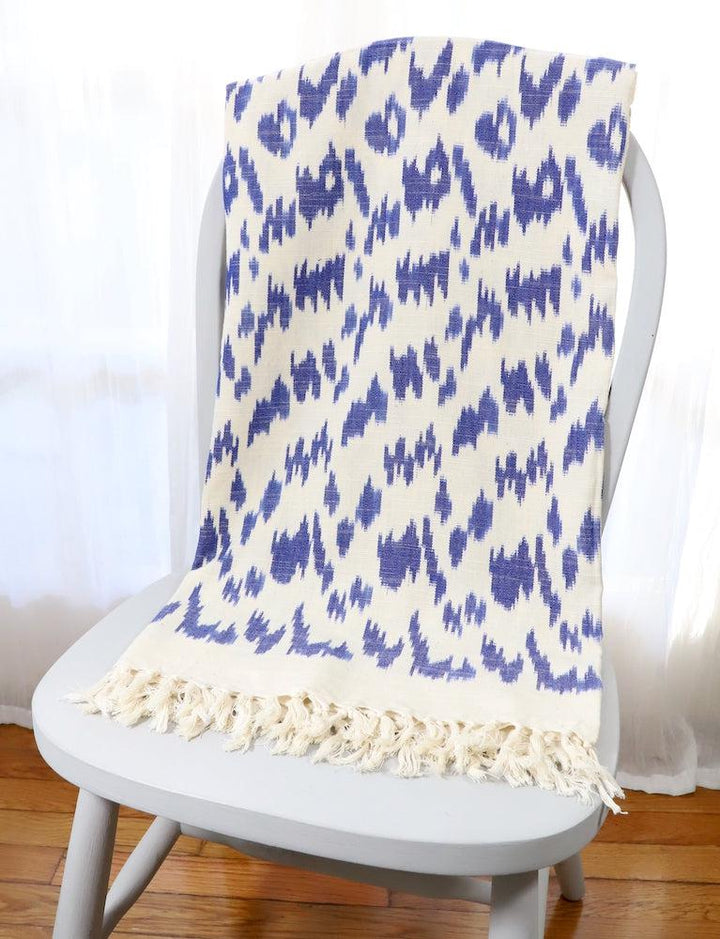 Handwoven cotton throw in a blue ikat pattern.