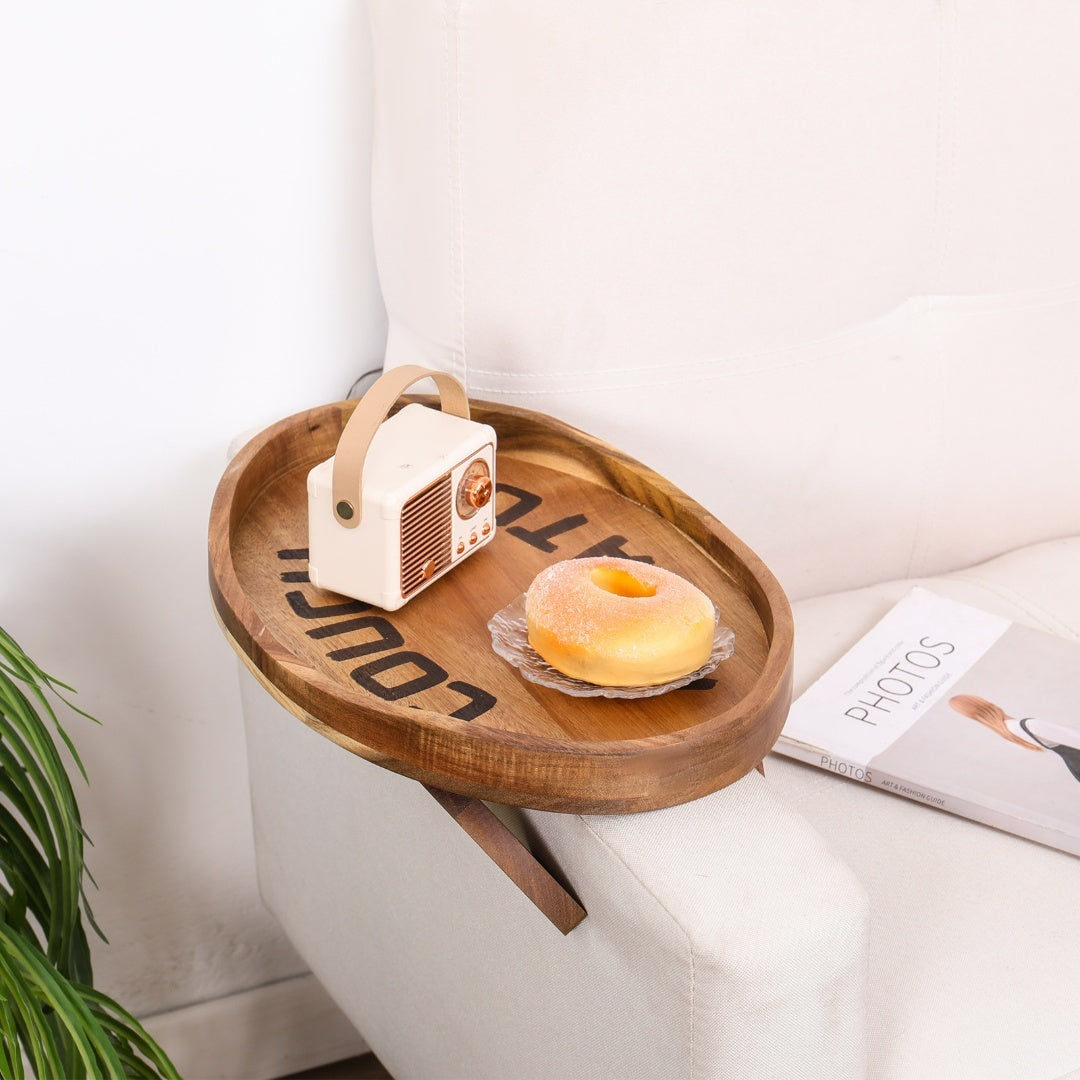 Couch Potato Clip-On Sofa Tray in acacia wood with metal clip, designed to hold snacks or drinks on a sofa armrest.