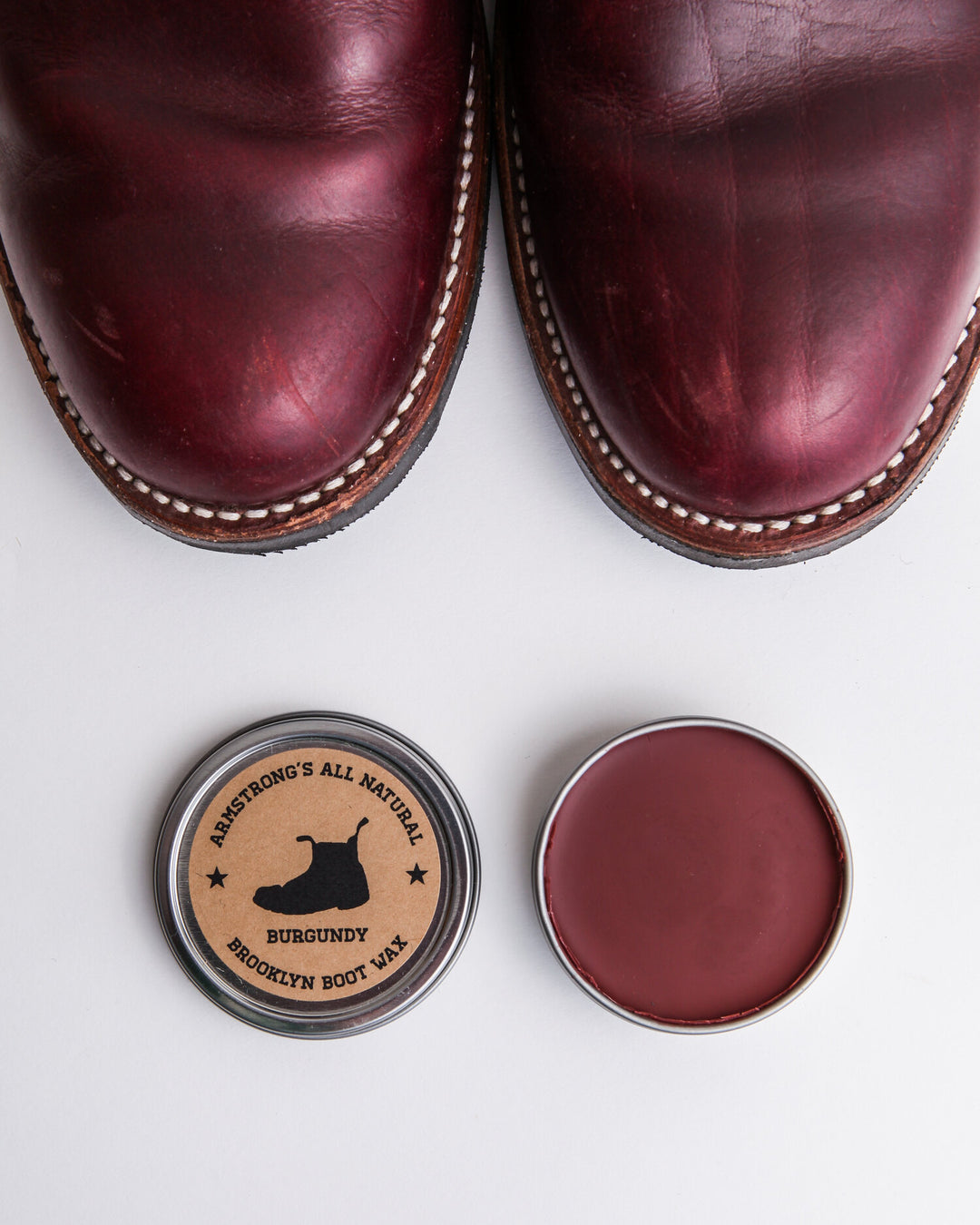 Brooklyn Boot Wax in pigmented black, shown applied to a leather boot.