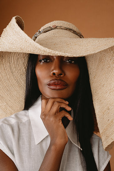 The Grand Belmont wide-brim straw sun hat, hand-braided from natural straw.