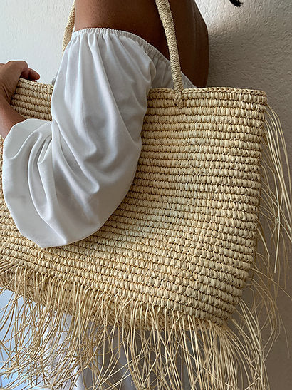 Handwoven crochet fringe tote bag with a natural woven design.