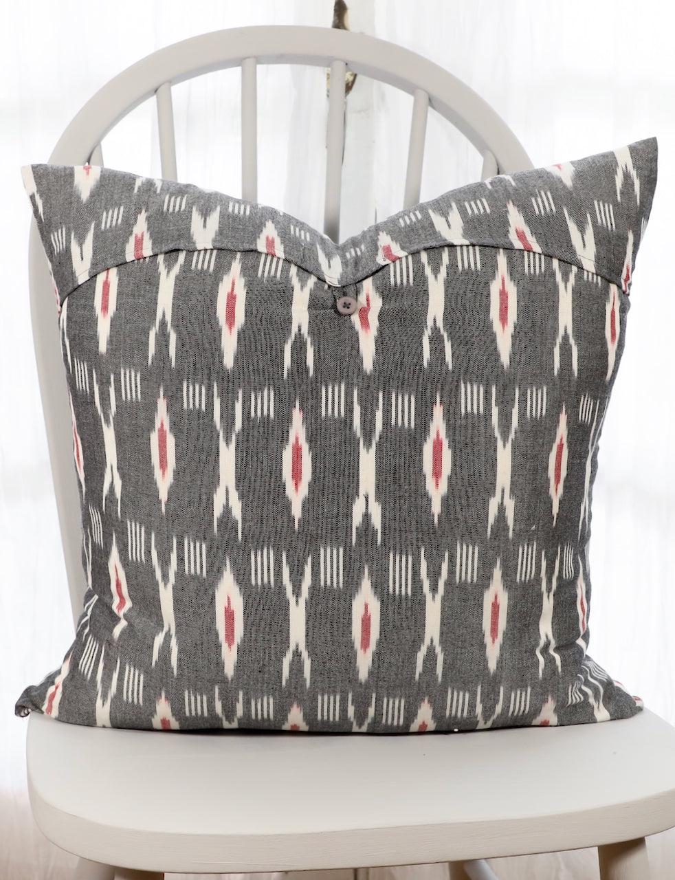 Grey and red XO ikat cotton throw pillow cover, close-up of the pattern.